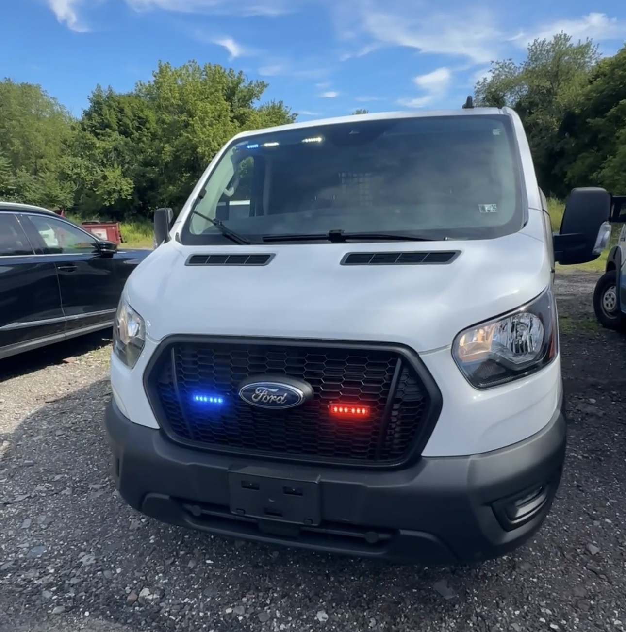 Red and blue emergency warning lights installed on a Ford Transit